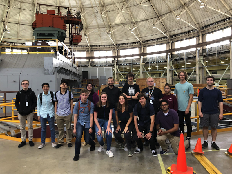 Group picture of 14 young people inside a historic building.