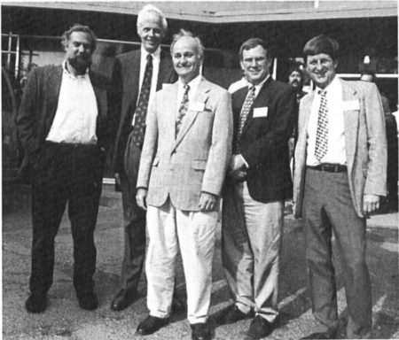 Old black and white photo of five men posing for a group picture while attending a conference.