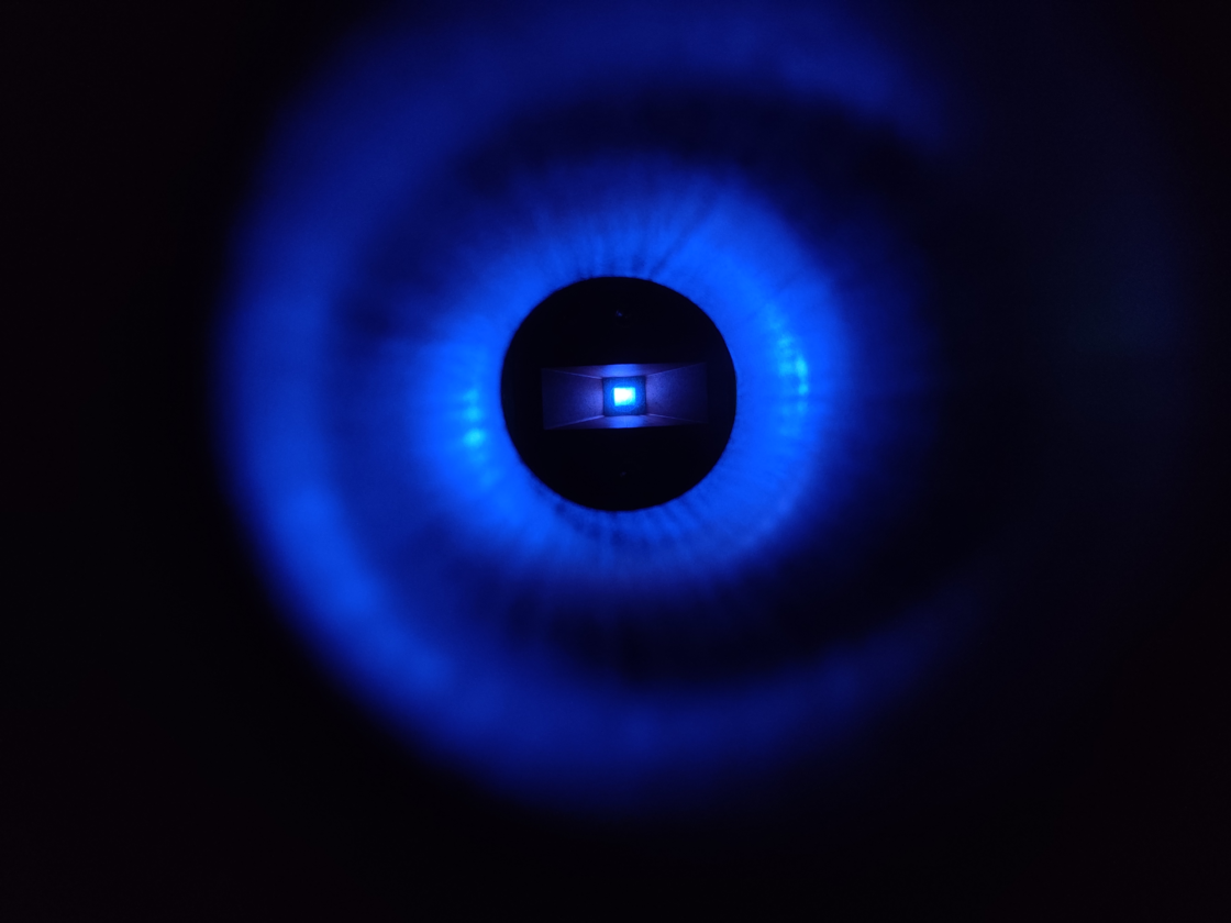 two blue rings around bright blue rectangle on black background