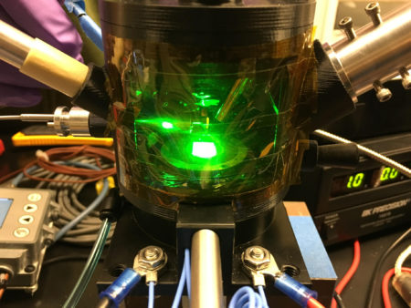 Photo of sample chamber with green glow.