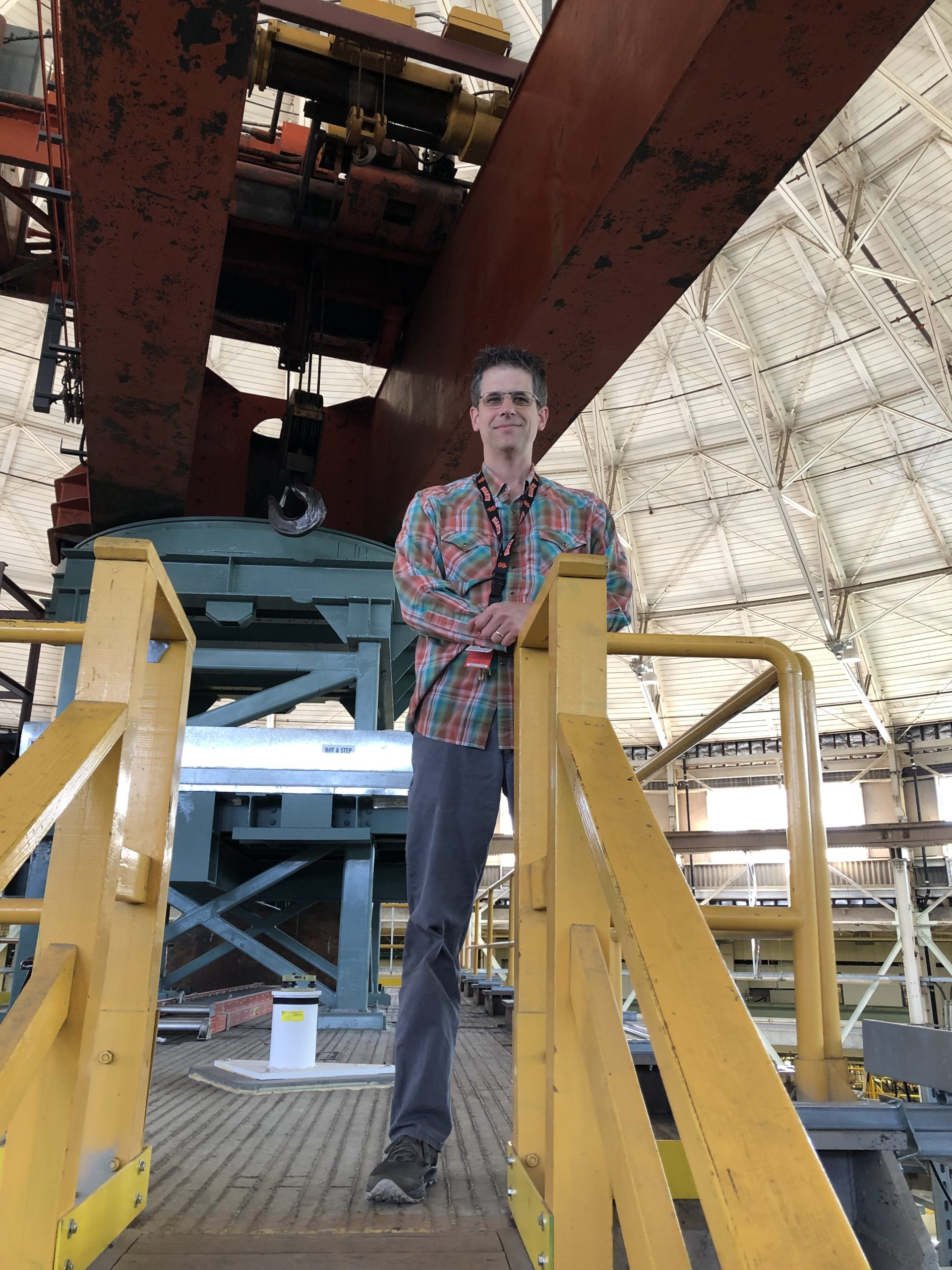 Jeff Troutman standing on top of the magnet yoke and under the orange crane