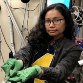 woman wearing green lab gloves