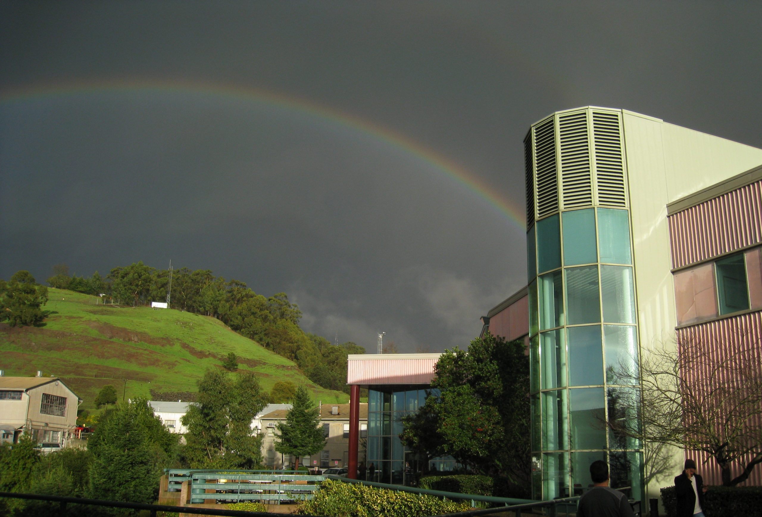 Rainbow against a dark grey sky ending at the ALS