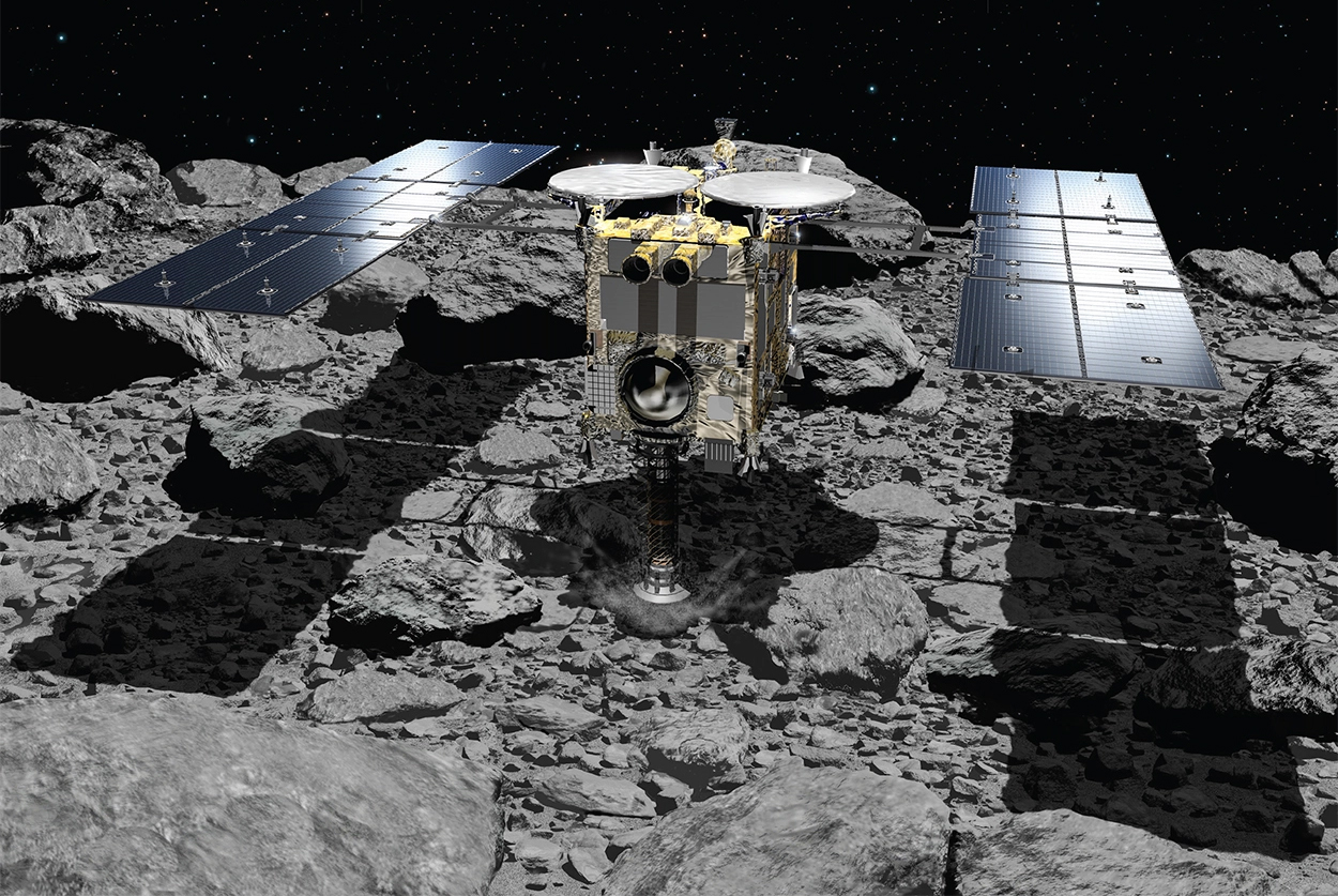 A spacecraft, with two solar panels extending from its sides, sits on a rocky asteroid surface in bright sunlight with a dark, starry sky in the background.