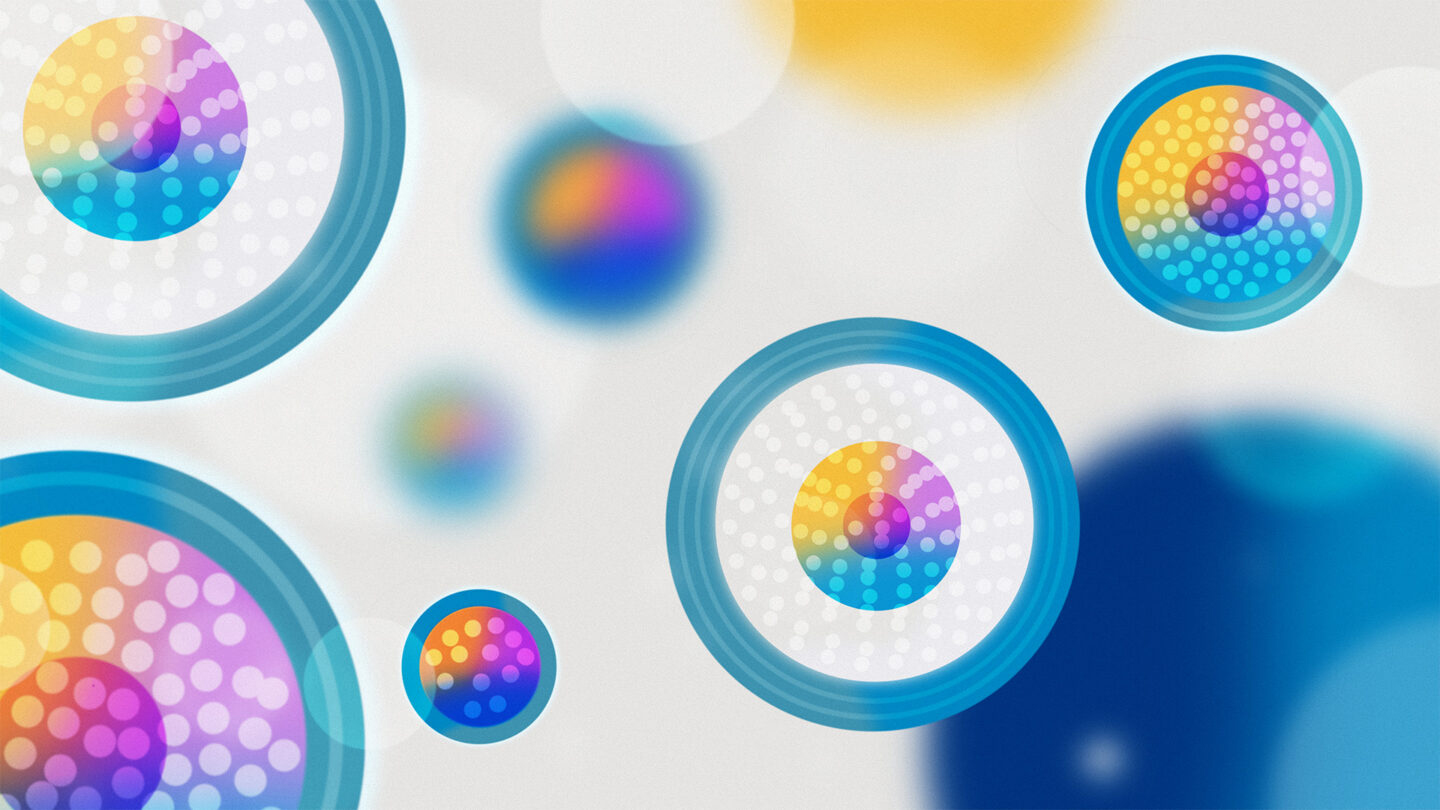 Colorful illustration of 2D circles of various sizes with different internal structures, indicated by blue outer shells, white dots, and multicolored centers.