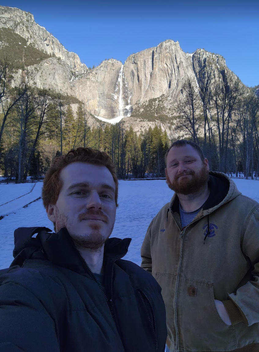 Two men in front of snow and a mountain