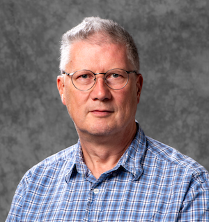 man wearing glasses and blue checked shirt