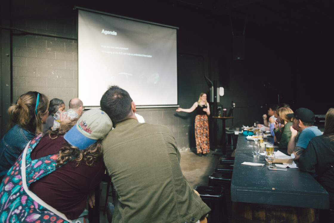 Two people enjoying a lecture in front of a screen.