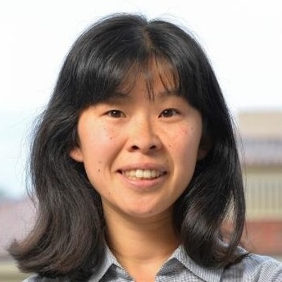 woman with shoulder-length hair and bangs
