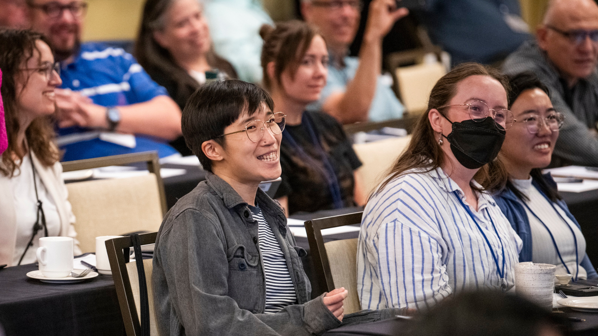 People sitting in a room smiling.