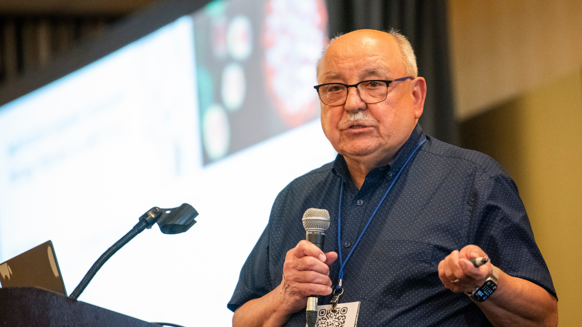 Man using microphone and presenting a talk. 
