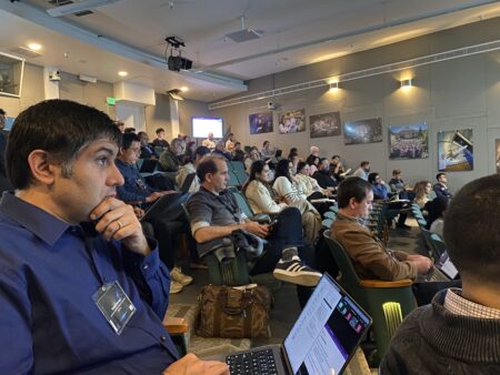 A large number of people sitting in an auditorium.