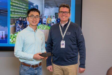 Two people smiling at the camera