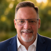 Headshot of man with glasses and facial hair