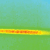A bright, elongated horizontal feature with intense yellow and red coloring set against a muted blue and green background.