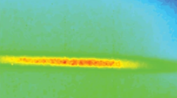A bright, elongated horizontal feature with intense yellow and red coloring set against a muted blue and green background.